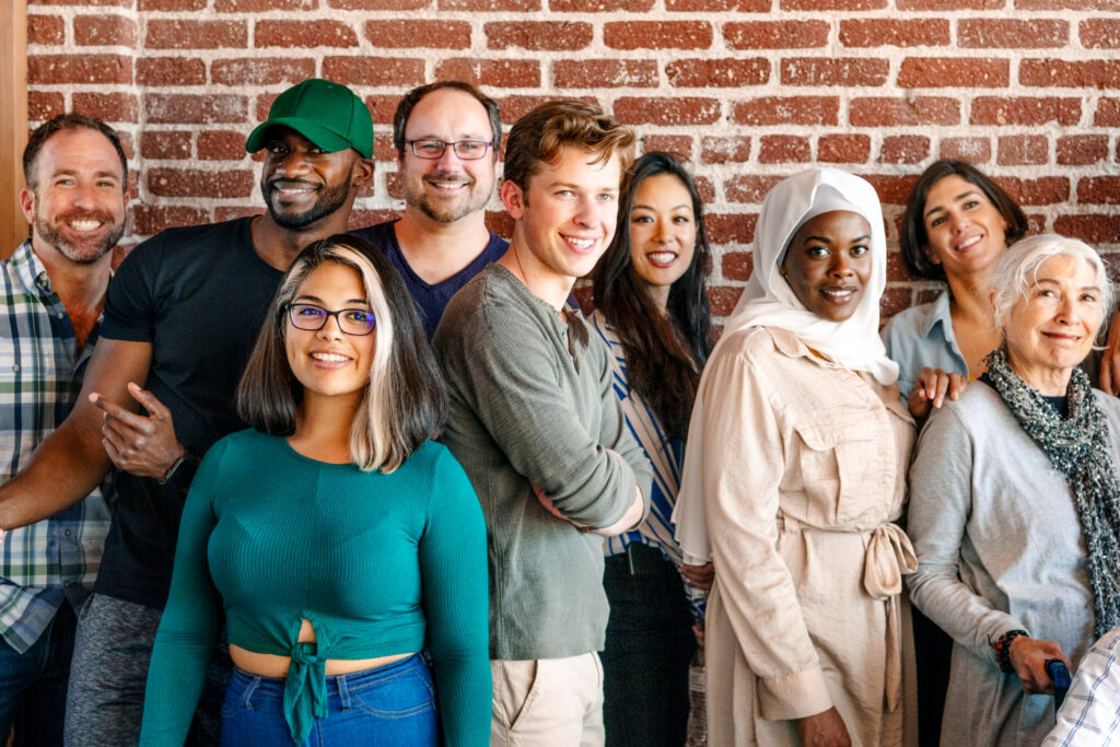 Group diverse people standing front brick wall